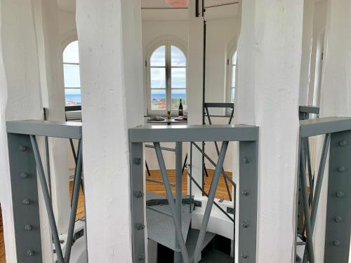 a room with two windows and a table and chairs at Ystads Gamla Vattentorn in Ystad