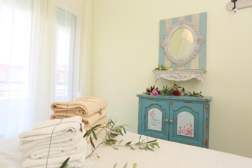 a bedroom with a blue cabinet and a mirror at Elia in Skála Foúrkas