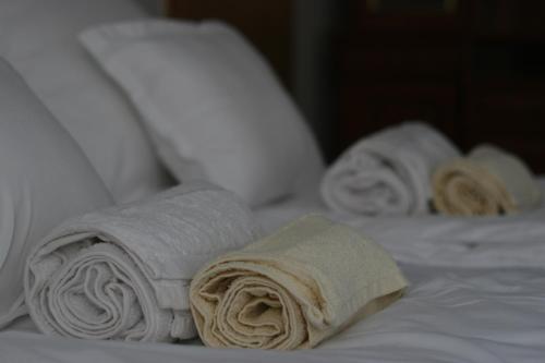 a group of towels sitting on top of a bed at Central Pécs Free Parking in Pécs