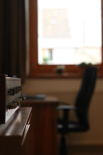 a black chair sitting in front of a kitchen counter at Central Pécs Free Parking in Pécs