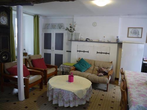 a living room with a couch and a table at les Miquelots in Pont-d'Ouilly