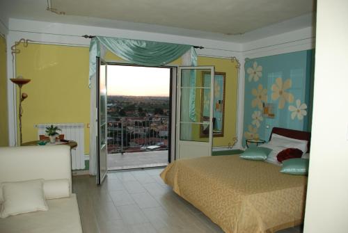a bedroom with a bed and a view of a city at La Chandelle in Massarosa