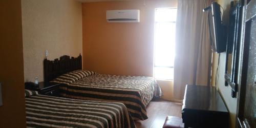 Ένα ή περισσότερα κρεβάτια σε δωμάτιο στο Hotel Colon Express