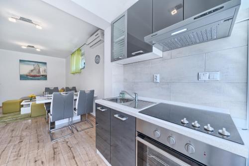 a kitchen with a sink and a counter top at Apartments Meštrović with heated swiming pool- near Split in Kaštela