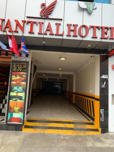 a hallway to a restaurant with a sign on the wall at Hotel Manantial No,002 in Lima