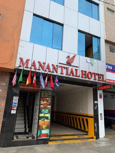 a manantial hotel with flags hanging outside of it at Hotel Manantial No,002 in Lima