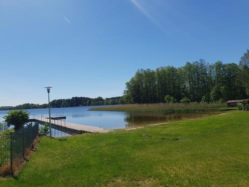 a view of a lake with a dock at Ostoja Becejły in Szypliszki
