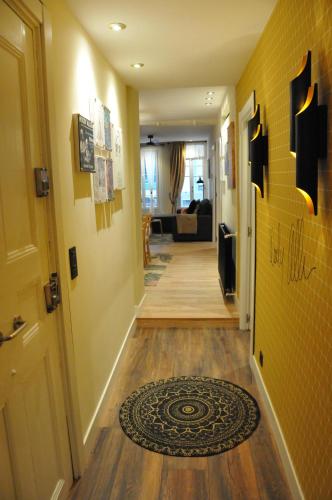 a hallway of a house with a rug on the floor at Pensión Boutique Caravan Cinema in Bilbao