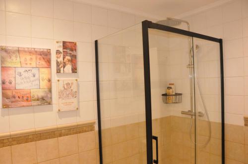 a shower with a glass door in a bathroom at Pensión Boutique Caravan Cinema in Bilbao