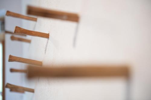a row of wooden crosses on a wall at Villa Ruah in Weissensee