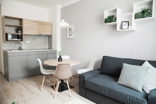 a living room with a couch and a table at HONEST Smichov in Prague