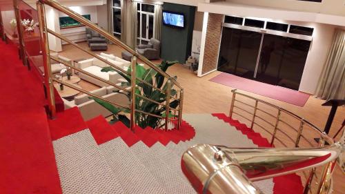 a staircase in a building with a red carpet at CATANGE HOTEL in Charata