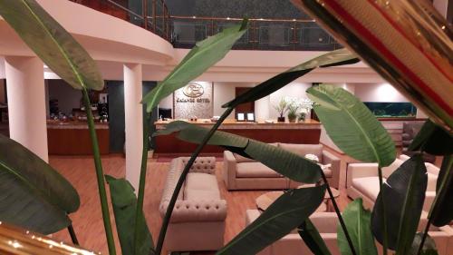 a lobby with a bar with chairs and plants at CATANGE HOTEL in Charata