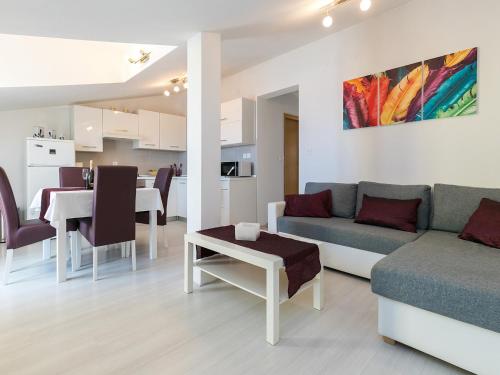 a living room with a couch and a table at Apartments Olea in Poreč