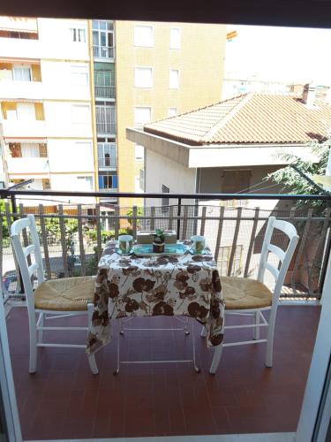 a table and two chairs on a balcony at Sandra Camporosso in Camporosso
