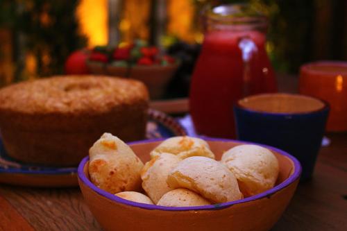 a bowl of food on a table with a cake at Green 53 Boutique Hotel in Ilhéus