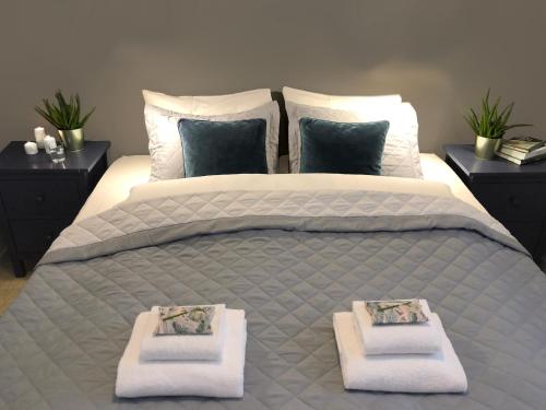 a bedroom with a large bed with towels on it at Norway Holiday Apartments - Norddalstunet in Norddal