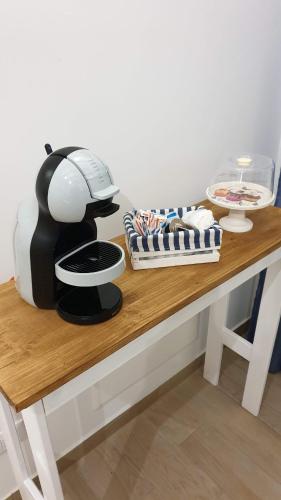 a table with a coffee maker on top of it at Ficodì apartments in Alcamo