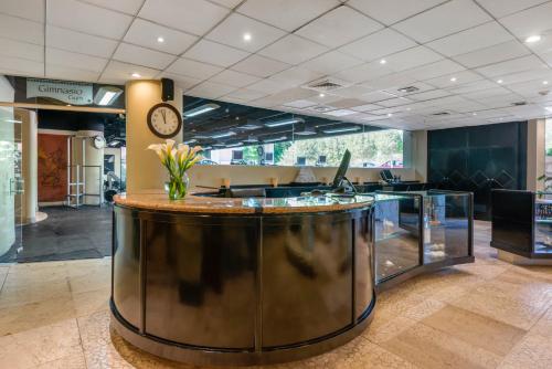 a large bar in a lobby with a clock at Wyndham Grand Cancun All Inclusive Resort & Villas in Cancún