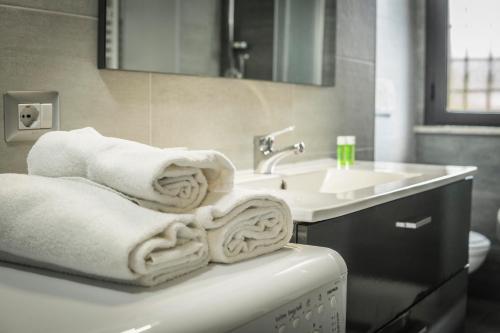 a bathroom with towels on a counter next to a sink at Modern Loft Apartment in Rome