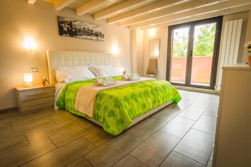 a bedroom with a large bed and a large window at Modern Loft Apartment in Rome