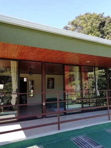a view of the outside of a house with glass windows at La Guayaba Monteverde in Monteverde Costa Rica