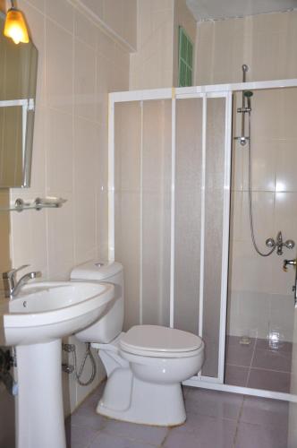 a bathroom with a toilet and a sink and a shower at Delphin Hotel Side in Side