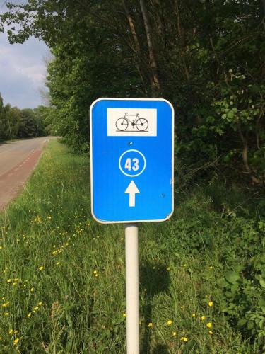 a blue sign on the side of a road with a bike at Villa van Brienen in Dilsen-Stokkem