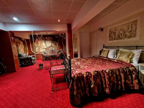 a bedroom with a large bed and red carpet at LEGENDS Chambers by Grand Pier Boutique in Bucharest