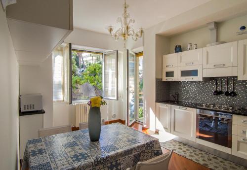a kitchen with a table with a vase on it at Casa Corallo Vicino alle Spiagge in Sanremo
