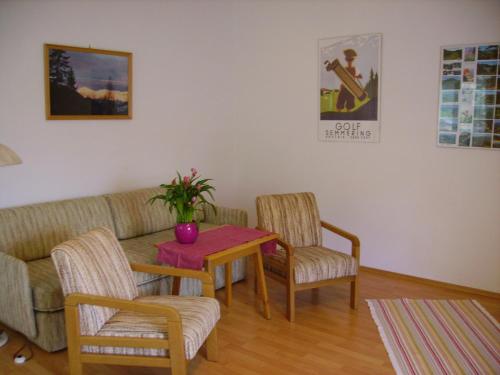 a living room with a couch and two chairs and a table at Villa Daheim Semmering in Semmering