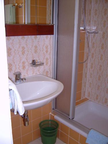a bathroom with a sink and a shower at Villa Daheim Semmering in Semmering
