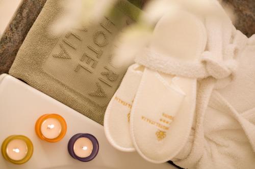 a pile of towels and candles on a table at Astoria Hotel Italia in Udine