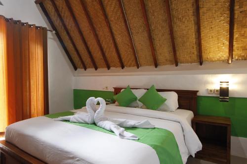 Ένα ή περισσότερα κρεβάτια σε δωμάτιο στο Jingga Bungalow Penida