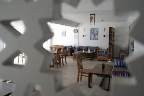a living room with chairs and tables and a dining room at Imsouane Magic House in Imsouane