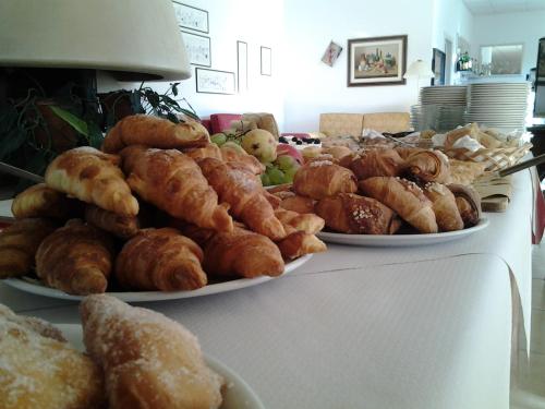 a table with three plates of pastries and other foods at Delle Rose, Hotel & Horse Riding in Torre Vado
