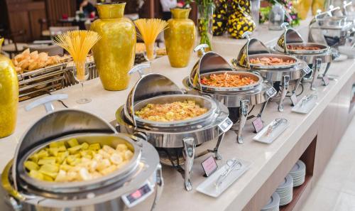 a buffet line with many buffet dishes of food at Muong Thanh Luxury Bac Ninh Hotel in Bắc Ninh