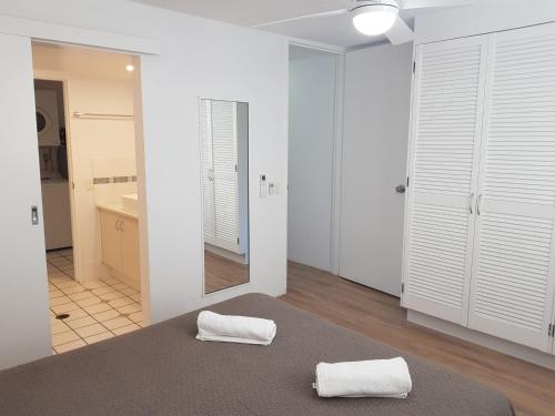 Un dormitorio con una cama con dos toallas encima. en Casablanca Beachfront Apartments, en Caloundra