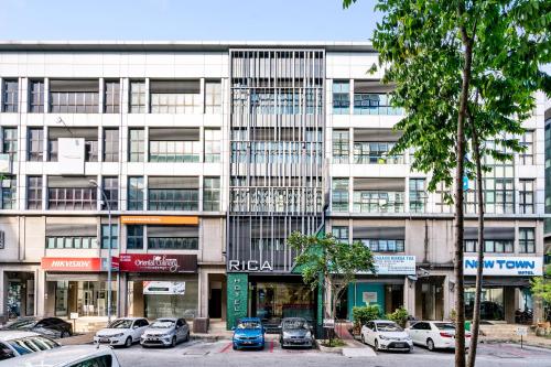 a large building with cars parked in front of it at Rica Hotel Usj in Subang Jaya