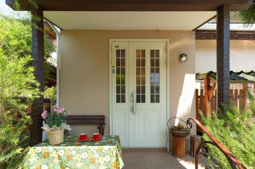 a front door of a house with a table at AbbeyRoad Inn Seika in Seika
