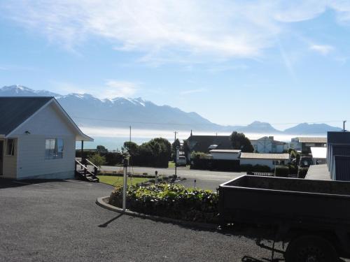 a view of a parking lot with mountains in the background at The Peninsula Kaikoura in Kaikoura
