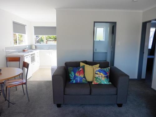 a living room with a couch and a table at Admiral Court Motel Kaikoura in Kaikoura