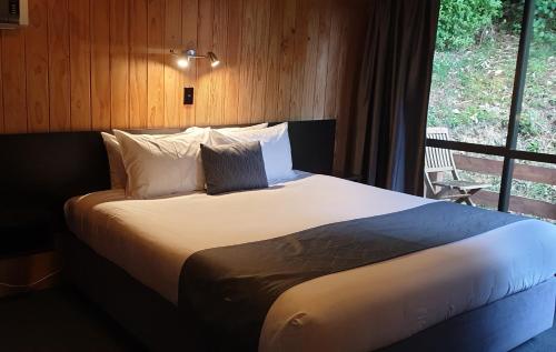 a large bed in a room with a window at Mt Vernon in Akaroa