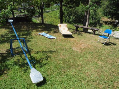 a mop and a chair and a bench in a yard at Apartments Gale in Delnice