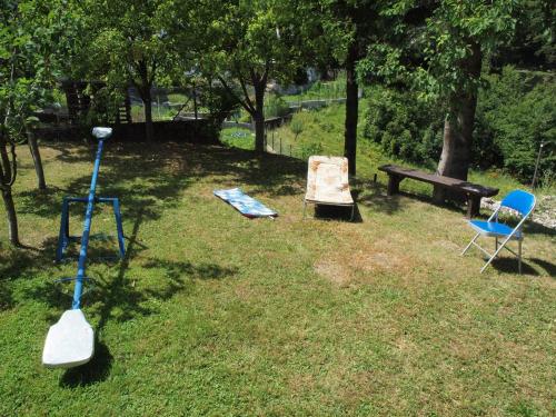 a park with two chairs and a table and a bench at Apartments Gale in Delnice