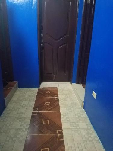 a blue room with a door and a tile floor at B&B KeisyAlba Punta Rucia in Punta Rucia