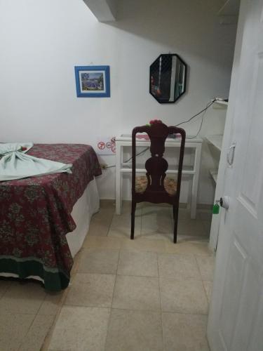 a room with a table and a chair and a bed at B&B KeisyAlba Punta Rucia in Punta Rucia