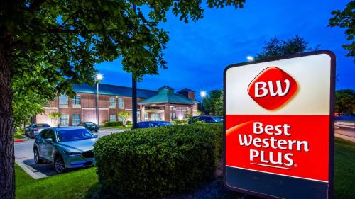 a sign for a buy best western plus at Best Western Plus Addison/Dallas Hotel in Addison