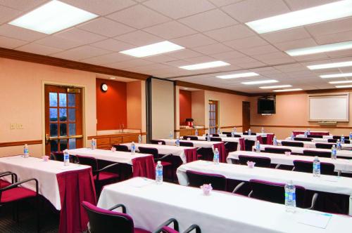a conference room with tables and chairs and a screen at Hyatt House Dallas Addison in Addison