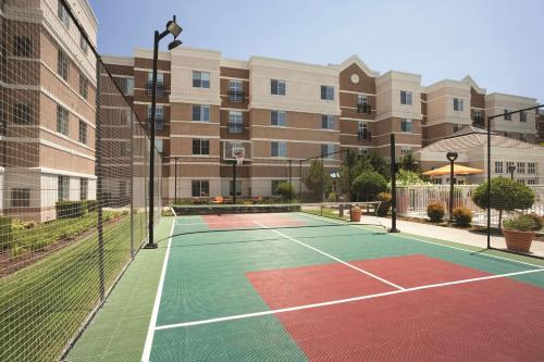 a tennis court in front of a building at Hyatt House Pleasant Hill in Pleasant Hill